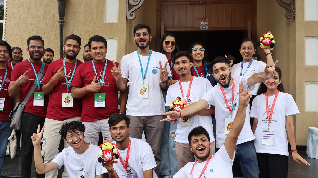 Ananta Mishra and fellow WordPress community members celebrating WordCamp Kathmandu outside Alice Receptions