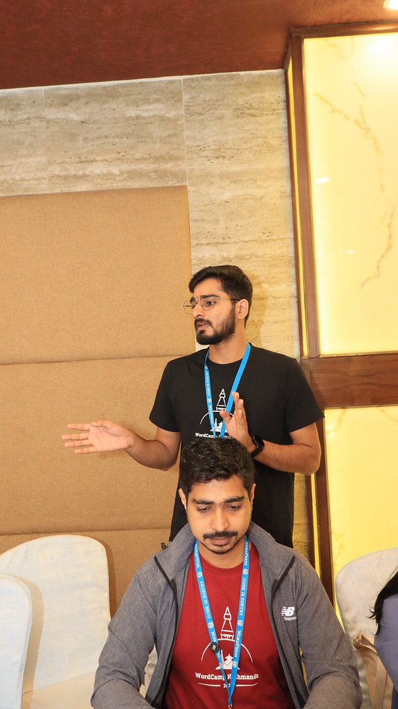 Ananta Mishra mentoring contributors at the WordPress Polyglots table during WordCamp Kathmandu Contributor Day