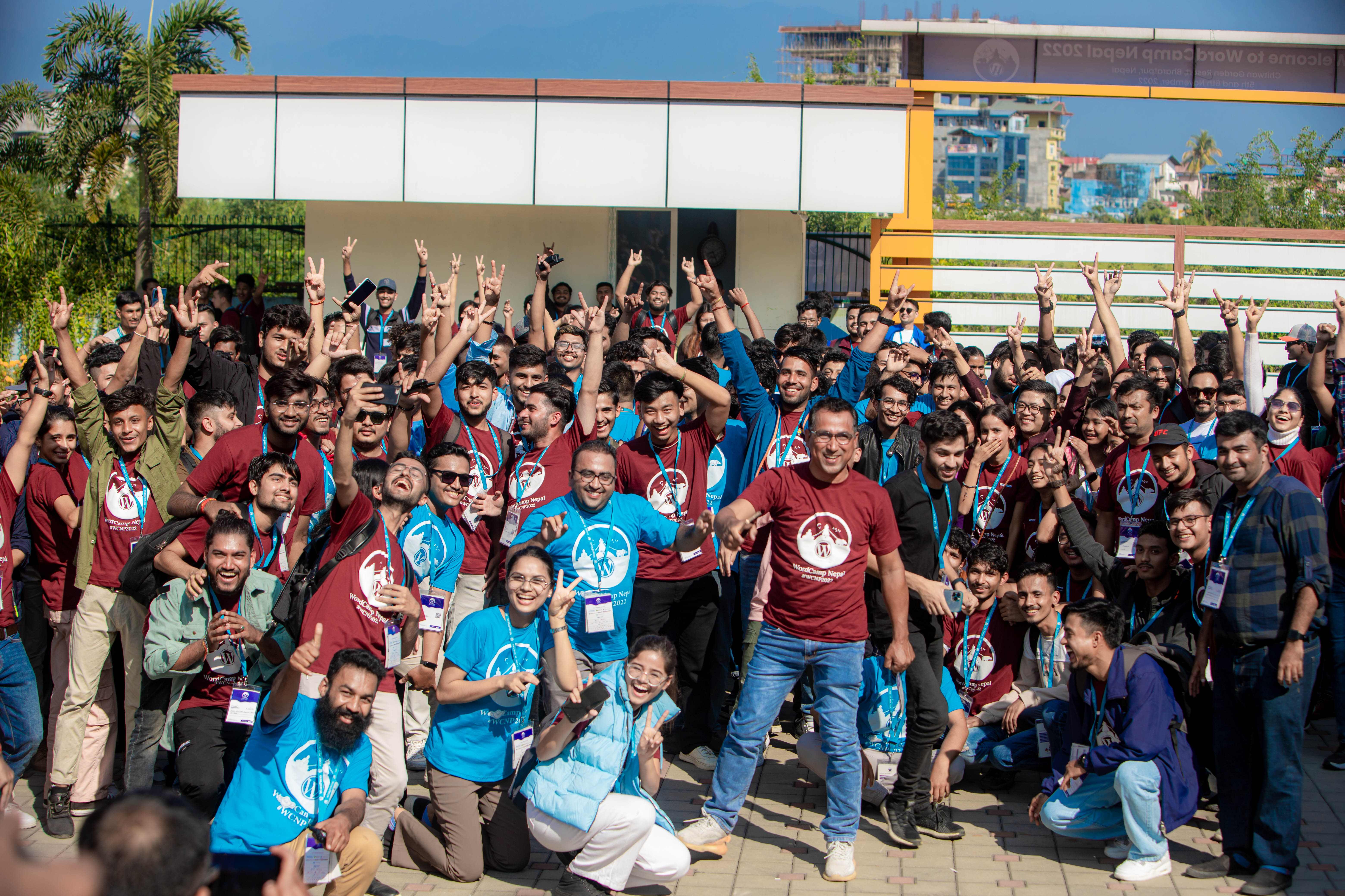 WordCamp Nepal 2022 community members outside the venue entrance arch