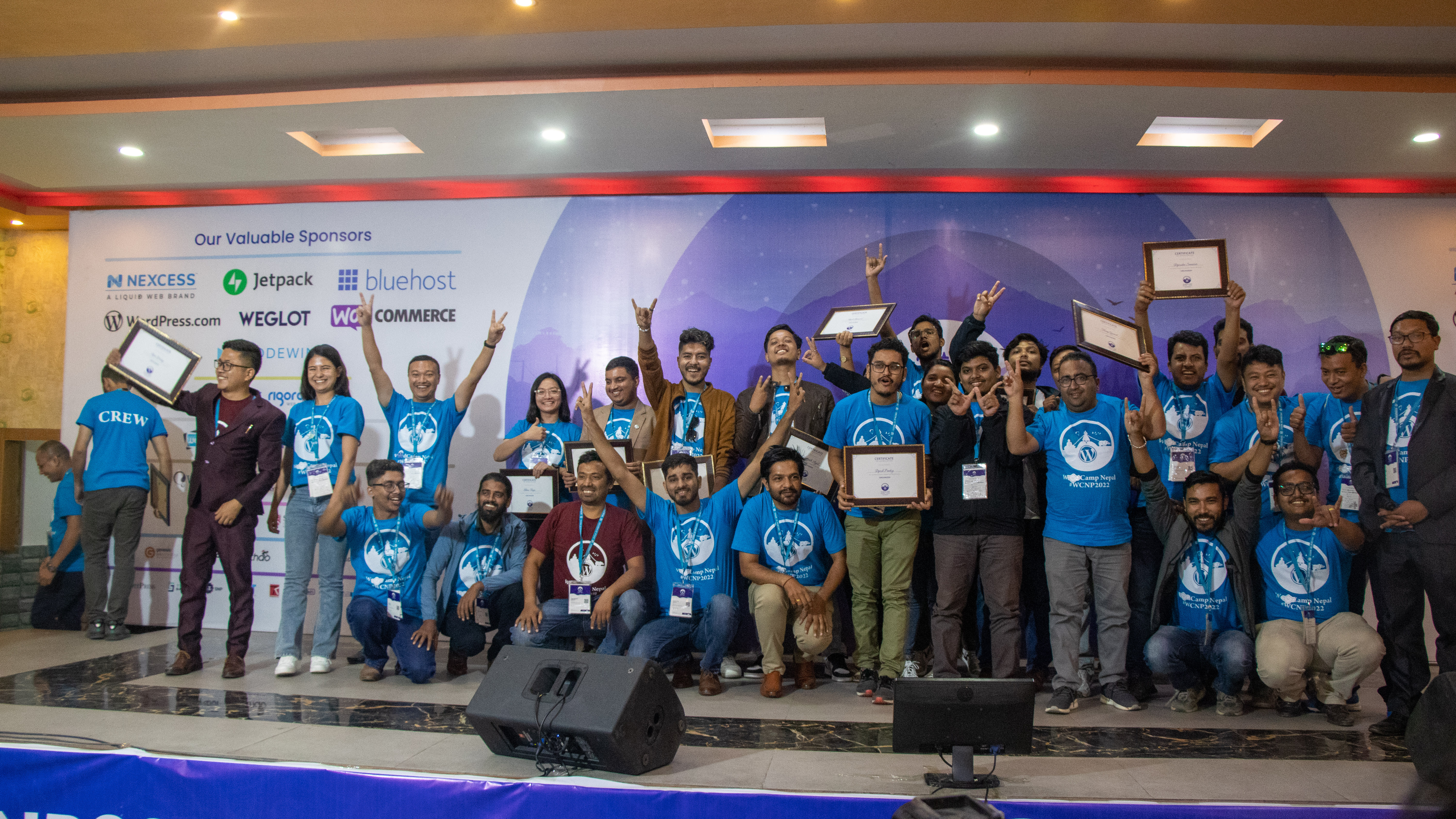 WordCamp Nepal 2022 organizing crew and volunteers celebrating on stage
