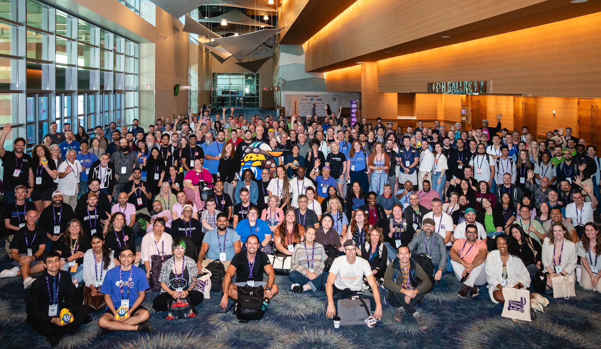 WordCamp US 2026 closing group photo with all attendees, organizers, and volunteers on the main stage