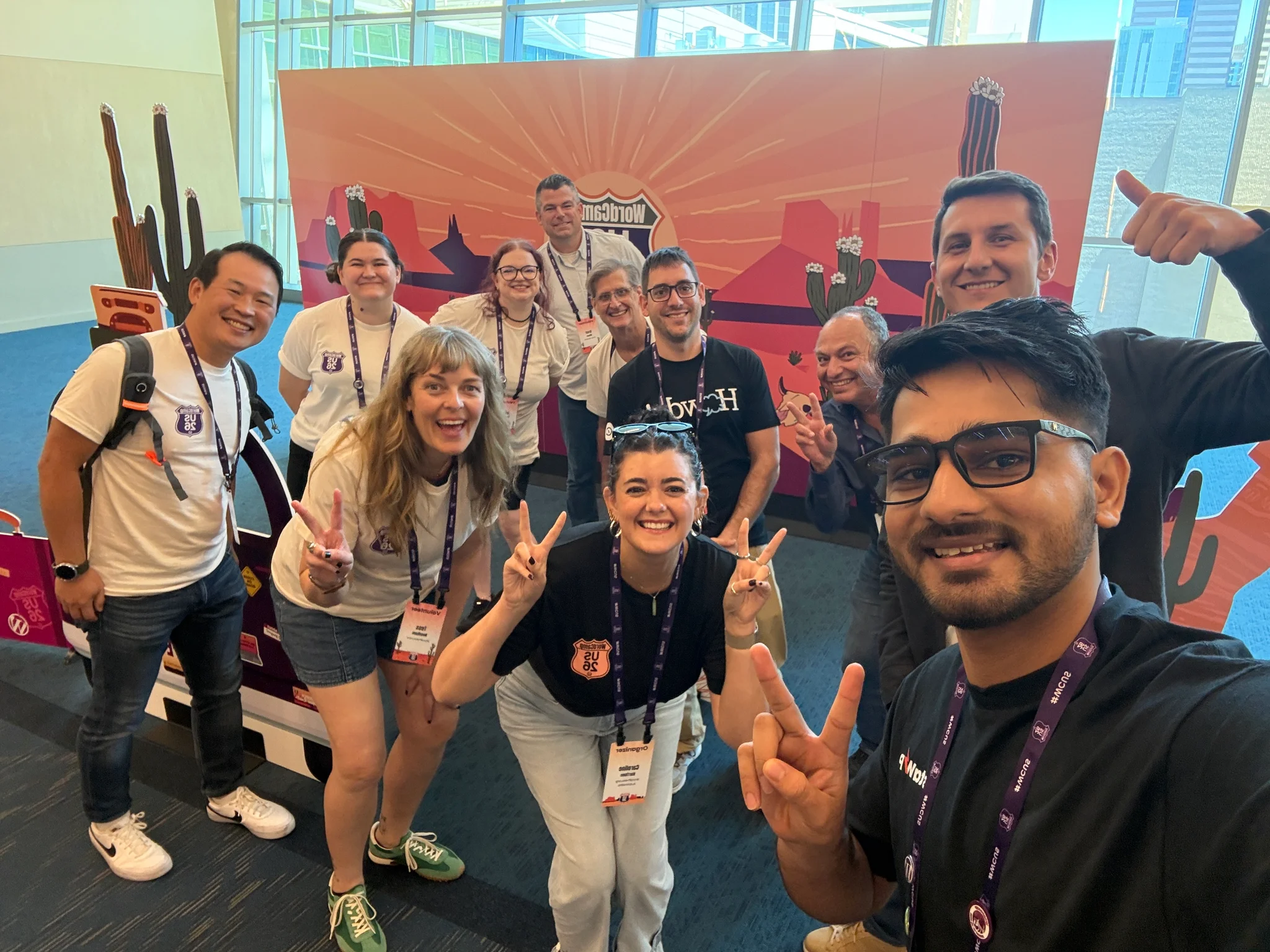 High-energy volunteer and organizer group selfie at the Arizona sunset photo booth